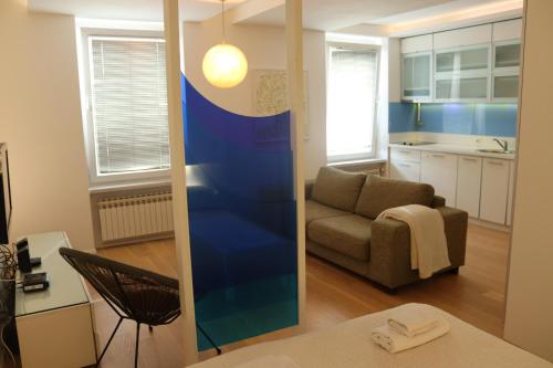 a living room with a couch and a table at Moonlight Shadow Apartment in Sarajevo