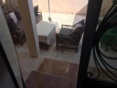 Blick auf ein Zimmer mit einem Bett und Stühlen in der Unterkunft Villa Said in Moulay Bousselham