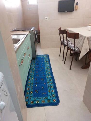 eine Küche mit einem blauen Teppich auf dem Boden in der Unterkunft Locazione turistica messapi in Manduria
