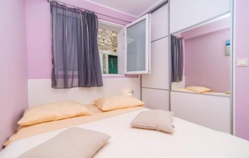 a bedroom with two beds and a mirror at Apartment Ina in Povlja