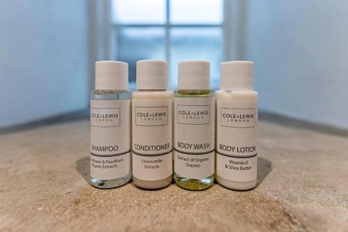 three bottles of essential oils sitting on a table at Hall View Guest Suite in Nunnington
