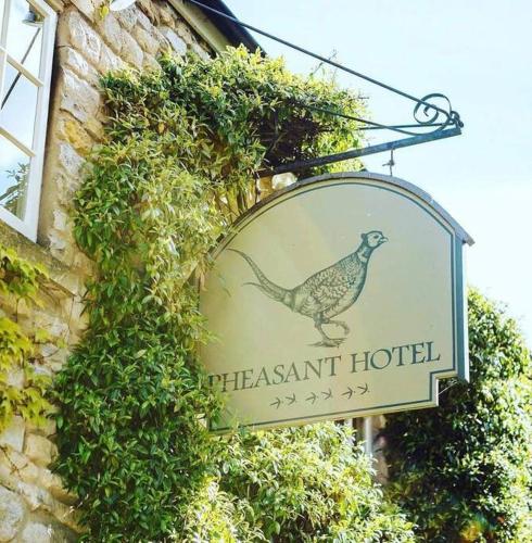 a sign for a pheasant hotel on the side of a building at Hall View Guest Suite in Nunnington