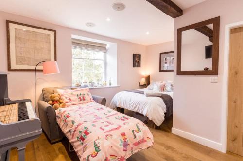 a bedroom with two beds and a bed with teddy bears at Hall View Guest Suite in Nunnington