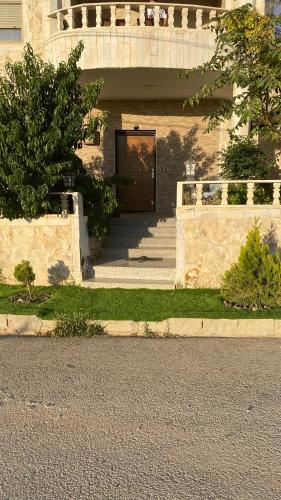 a front door of a building with a door at Petra Rose Apartment in Wadi Musa