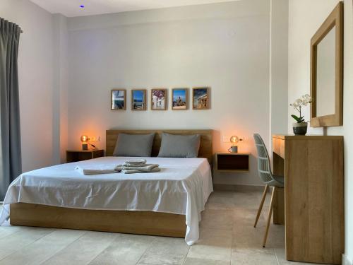 a bedroom with a bed with two tables and two lamps at Agiou Stilianou Apartments in Kallithéa