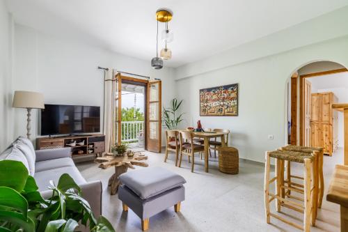 a living room with a couch and a table at Yianna Sunny Studios in Skopelos Town