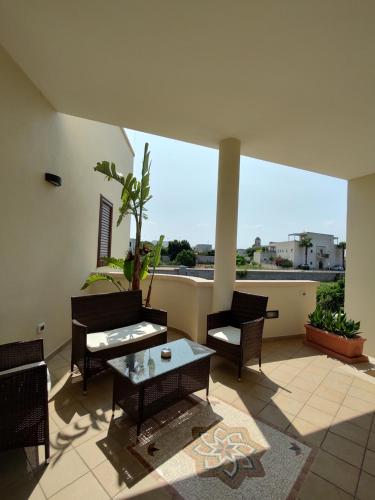 a living room with chairs and a table on a balcony at Vignali Residence in Diso