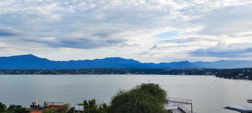 a view of a large body of water with mountains at Blessed Rest Home Teques in Tequesquitengo
