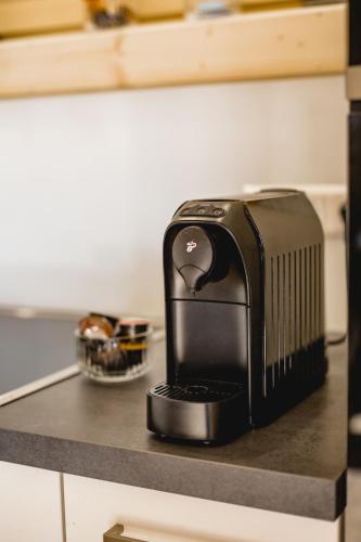 a black appliance sitting on top of a counter at Chalet 49 Nesselgraben - Ferienwohnungen aus Holz in Koppl
