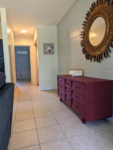a room with a dresser and a mirror on the wall at Pet friendly single story garden condominium in Gulfport