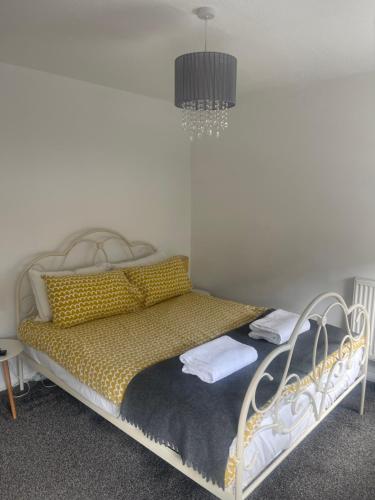 a bedroom with a bed with a chandelier above it at 2 bed house, walking distance Shrewsbury centre in Shrewsbury