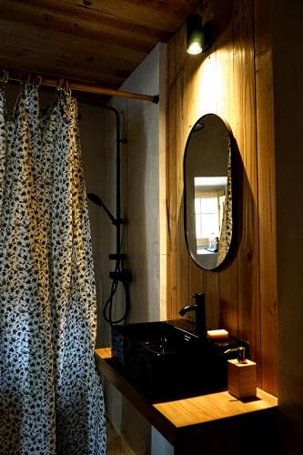a bathroom with a sink and a mirror at CAN TAT, Loft in a old coach house in Sant Jordi Desvalls