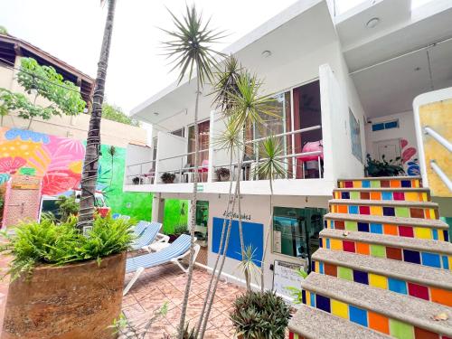 a house with a lot of plants in front of it at ITH Sayulita Amazing Surf Hostel in Sayulita