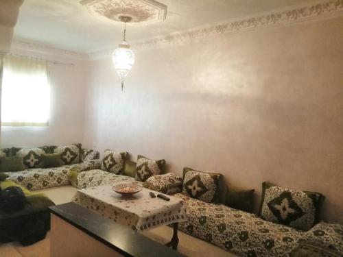a living room with a couch and a table at appartement traditional cozy in Tangier