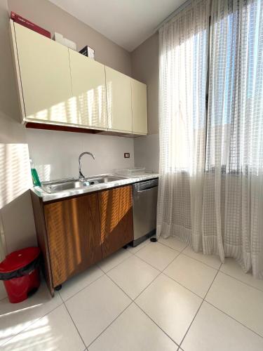 a small kitchen with a sink and a window at Brand New Apartament Durres in Durrës