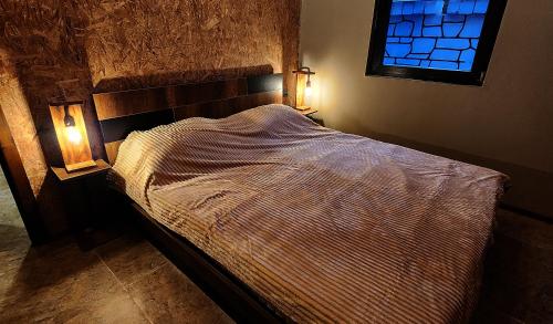 a bed in a bedroom with a window at HOLIDAY HOME in Nourkyshlak