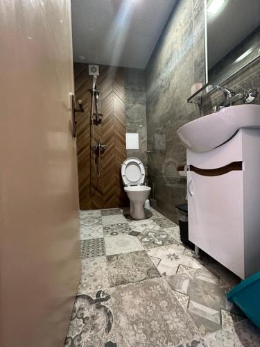 a bathroom with a sink and a toilet at La Kameya in Kiten