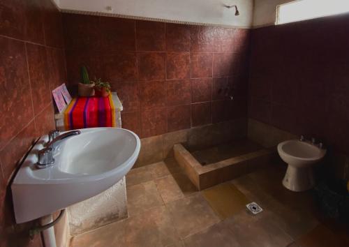 a bathroom with a sink and a toilet at Gran Casa Hostel&Camping in Tilcara