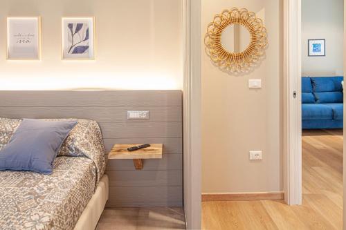 a bedroom with a bed and a mirror on the wall at La Casa dei Glicini in Levanto
