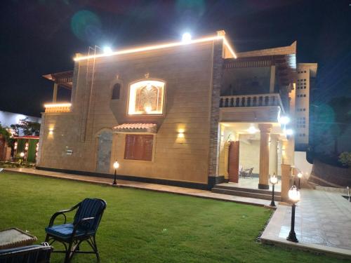 a house with a lawn in front of it at night at فيلا للايجار في مارينا 4 حمام سباحة خاص in El Alamein