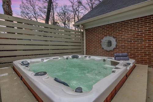 a hot tub in the backyard of a house at Cozy & Relaxing Home, Hot Tub, Fire Pit, Deck in Greensboro