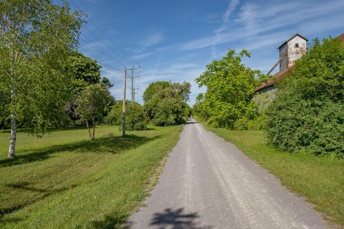 an empty road in a field with a house at Town & Trail - Walkable Wellington Charmer in Wellington