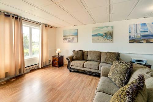 a living room with a couch and a window at Hannahs Place - Quaint and Cozy Apt by the Beach! in Emerald Isle