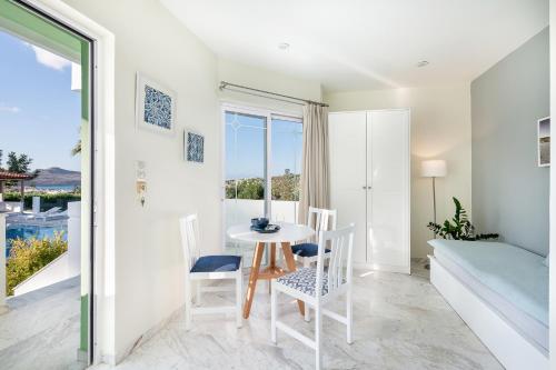 a small white dining room with a table and chairs at Villa Life in Agia Marina Nea Kydonias