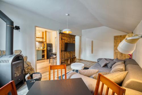 a living room with a couch and a table at Apartmány Pod Šerákem in Lipova Lazne