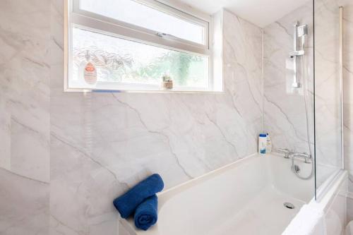 bagno con vasca bianca e finestra di Travellers' Choice in Harwich-Essex a Harwich