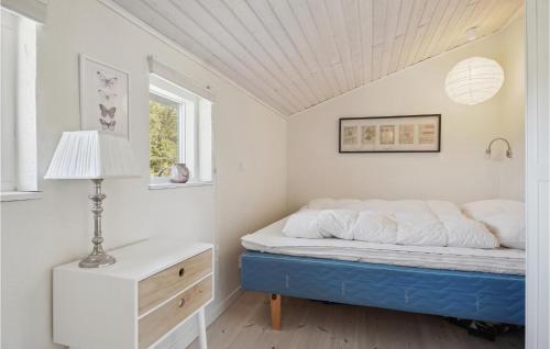 a bedroom with a bed and a lamp and a window at Amazing Home In Thisted With 3 Bedrooms And Wifi in Nørre Vorupør