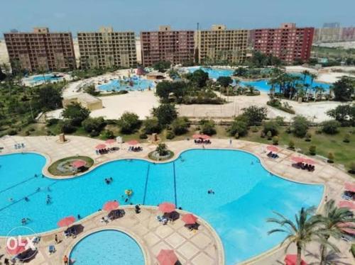 an aerial view of a large swimming pool in a resort at جولف بورتو مارينا in El Alamein