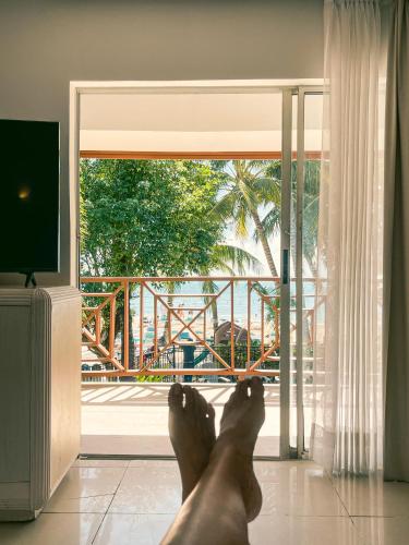 a person laying on the floor in front of a door at Hotel Cocoplum Beach in San Andrés