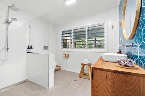 a bathroom with a sink and a shower at 24 Hyam Rd Hyams Beach in Hyams Beach