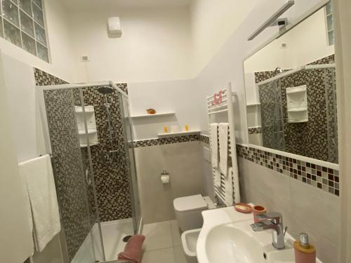 a bathroom with a shower and a sink and a toilet at Titi Rooms in La Spezia