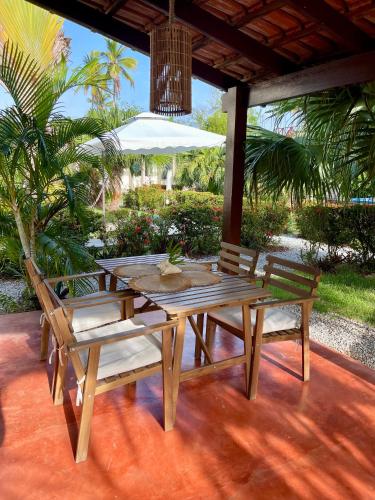 a wooden table and two chairs on a patio at 21 Palms in Las Galeras