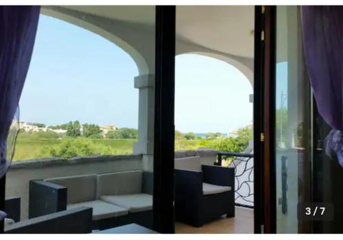 a view of a balcony with a couch and a window at Relax al Mare in Olbia