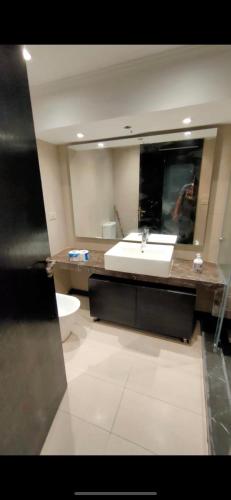 a bathroom with a sink and a toilet at Executive Royal Tower Apartments - Sky Lounge in El Alamein