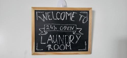a chalkboard sign with welcome to an open laundry room at Villa Hojnik in Videm pri Ptuju