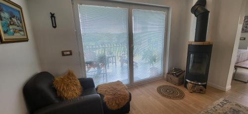 a living room with a couch and a large window at Villa Hojnik in Videm pri Ptuju