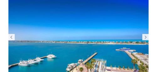 a view of a harbor with boats in the water at Executive Royal Tower Apartments - Sky Lounge in El Alamein