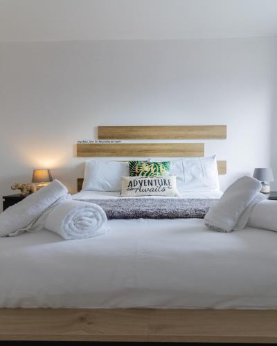 a bedroom with a large white bed with white pillows at Jucuzzi bath. Japanese toilet. Belfast City Centre. in Belfast