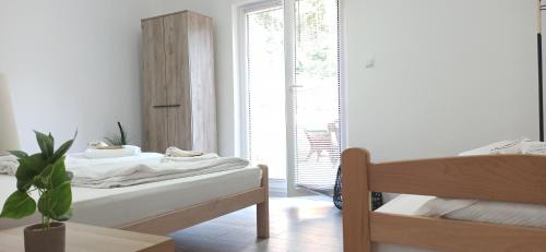 a white room with a bed and a window at Sunčani apartman 2 in Krupanj