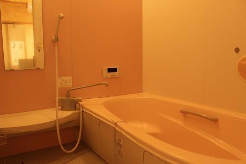 a bathroom with a tub and a toilet and a sink at Fuefuki - House - Vacation STAY 10281 in Fuefuki