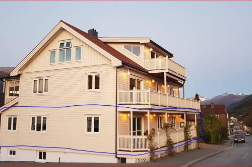 a house with a blue line on the side of it at Moen Booking in Åndalsnes