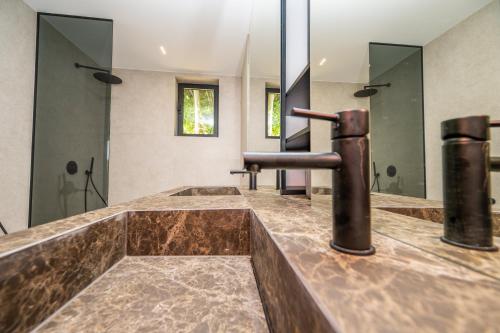 a bathroom with a brown counter top and a sink at The Villa O in Sarajevo