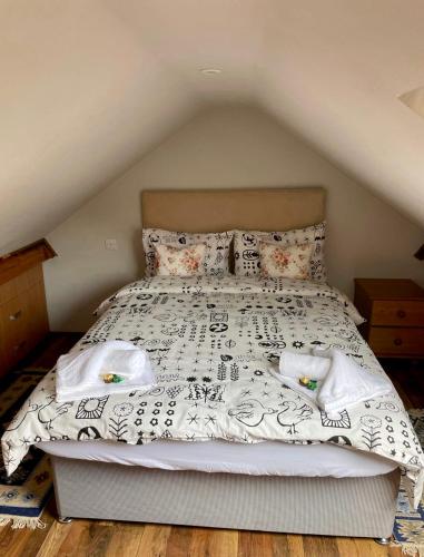 a bedroom with a bed with white sheets and pillows at Adina s House 5 Bedrooms in Rugeley