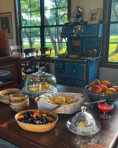 a table with bowls of fruit and other food on it at Inn at Sunset Mill Ranch in Wimberley