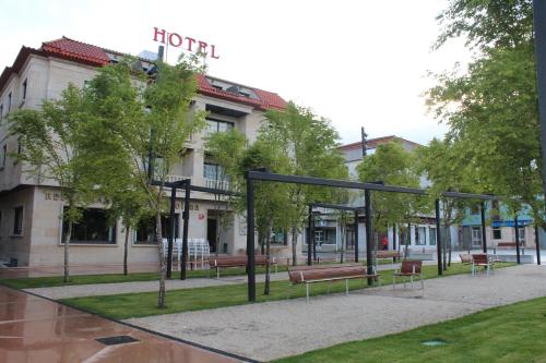 a group of benches in front of a hotel at Nueva Colina in Tomiño