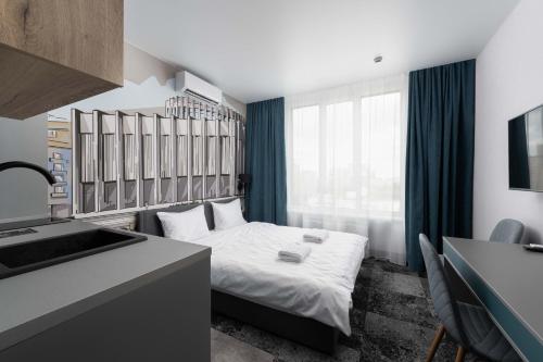 a hotel room with a bed and a sink at Be The One Hotel in Kyiv